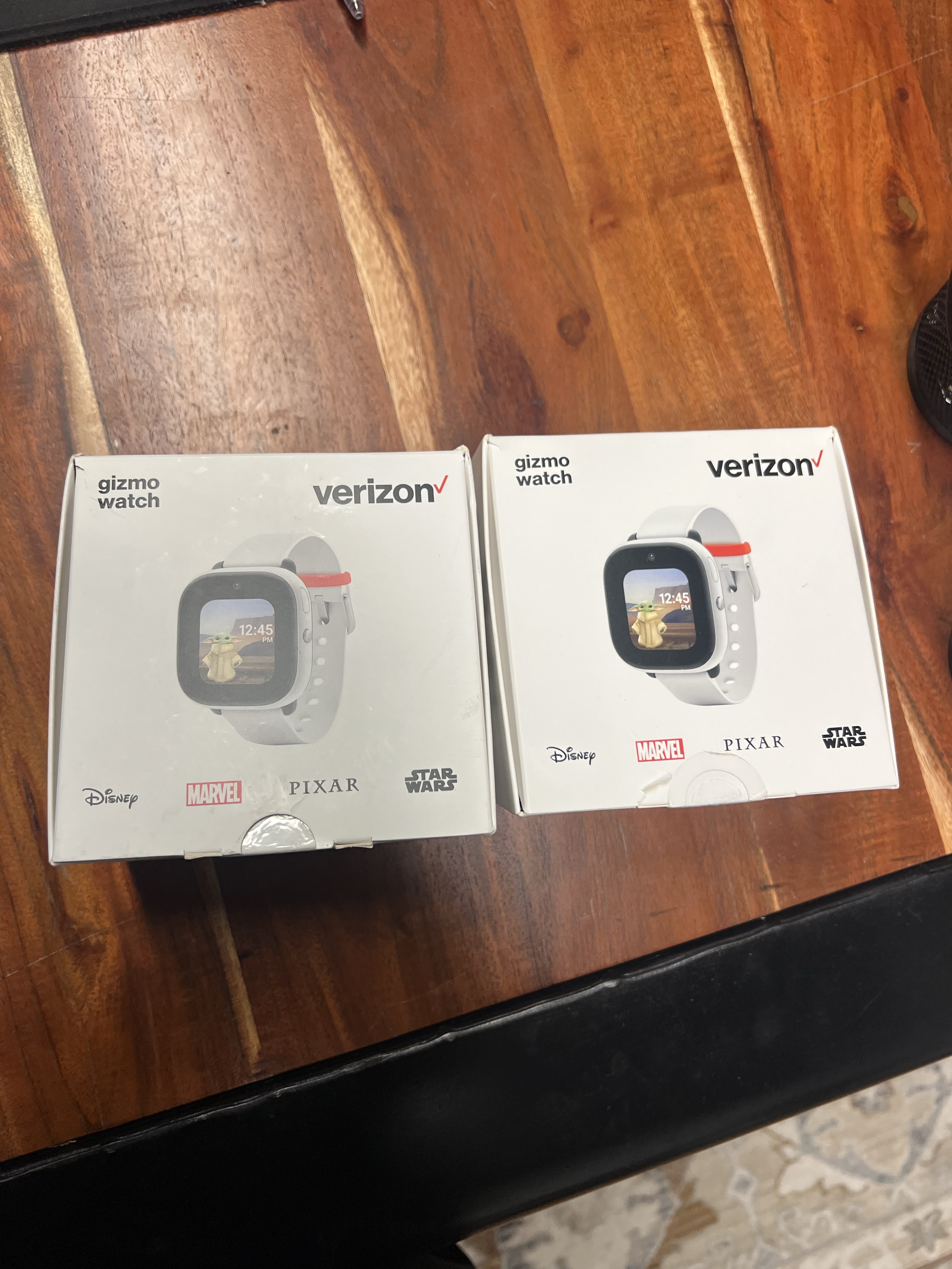Two Verizon GizmoWatch boxes side by side on a table